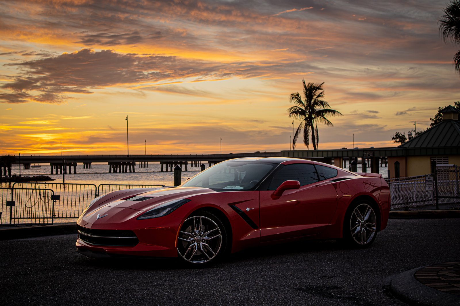 Red Corvette Stingray portrait at sunset by the water in Southwest Florida