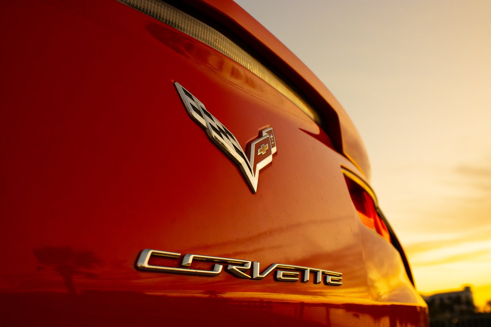 Corvette Stingray tail light close-up with sunset reflection — automotive detail photography