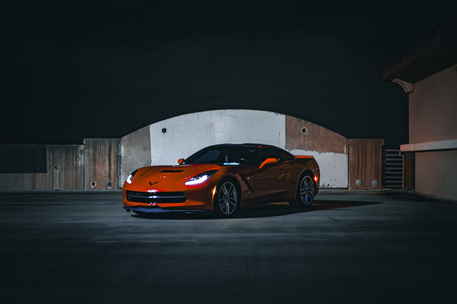 Illuminated Corvette tail light at night — cinematic automotive close-up
