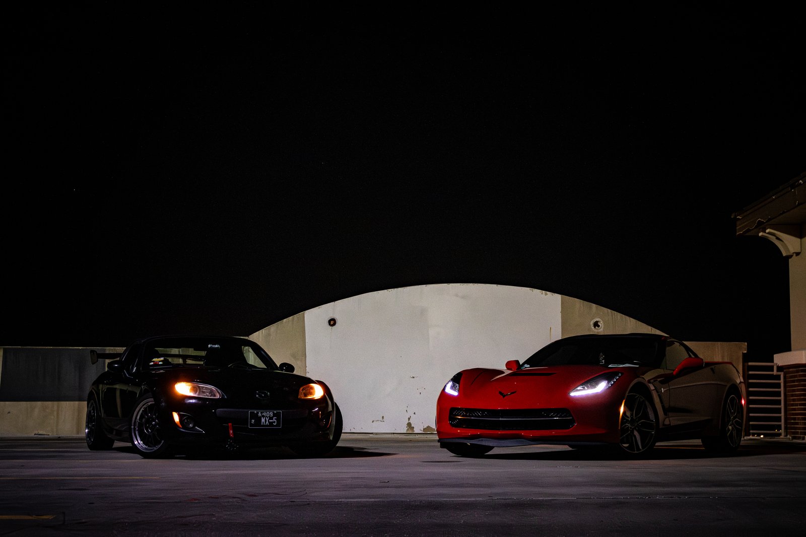Mazda MX-5 Miata under string lights and palm trees at night in Florida