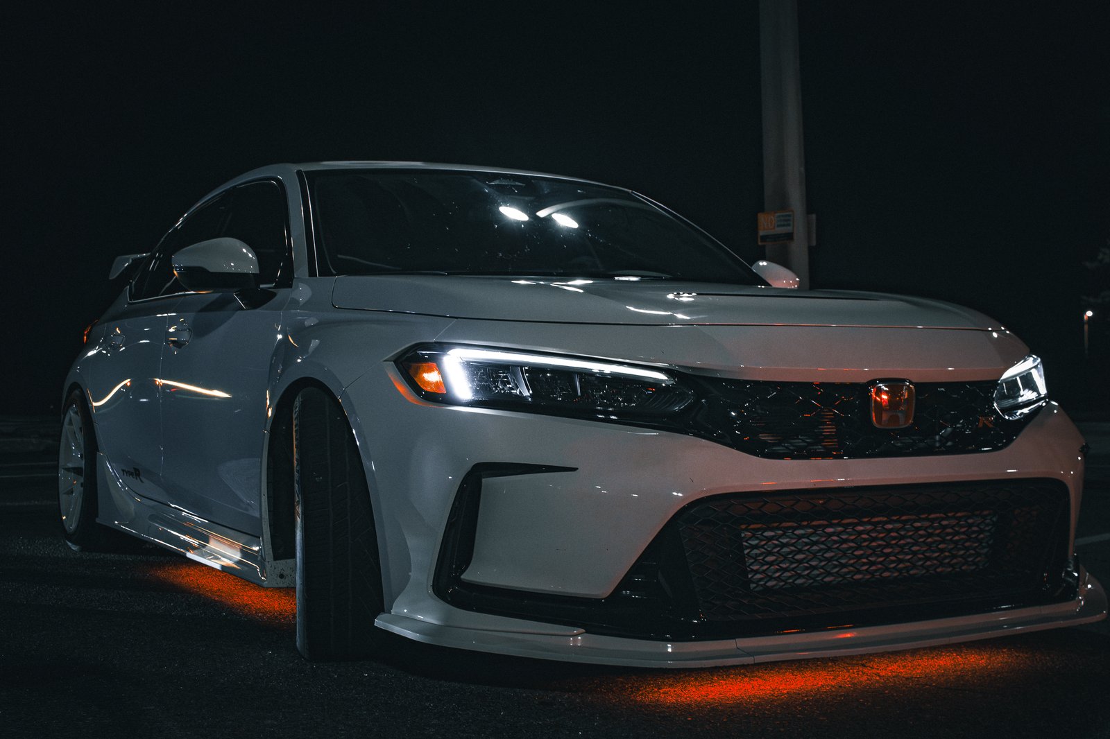 White Honda Civic Type R at night with headlights on and red underglow — JDM hot hatch photography