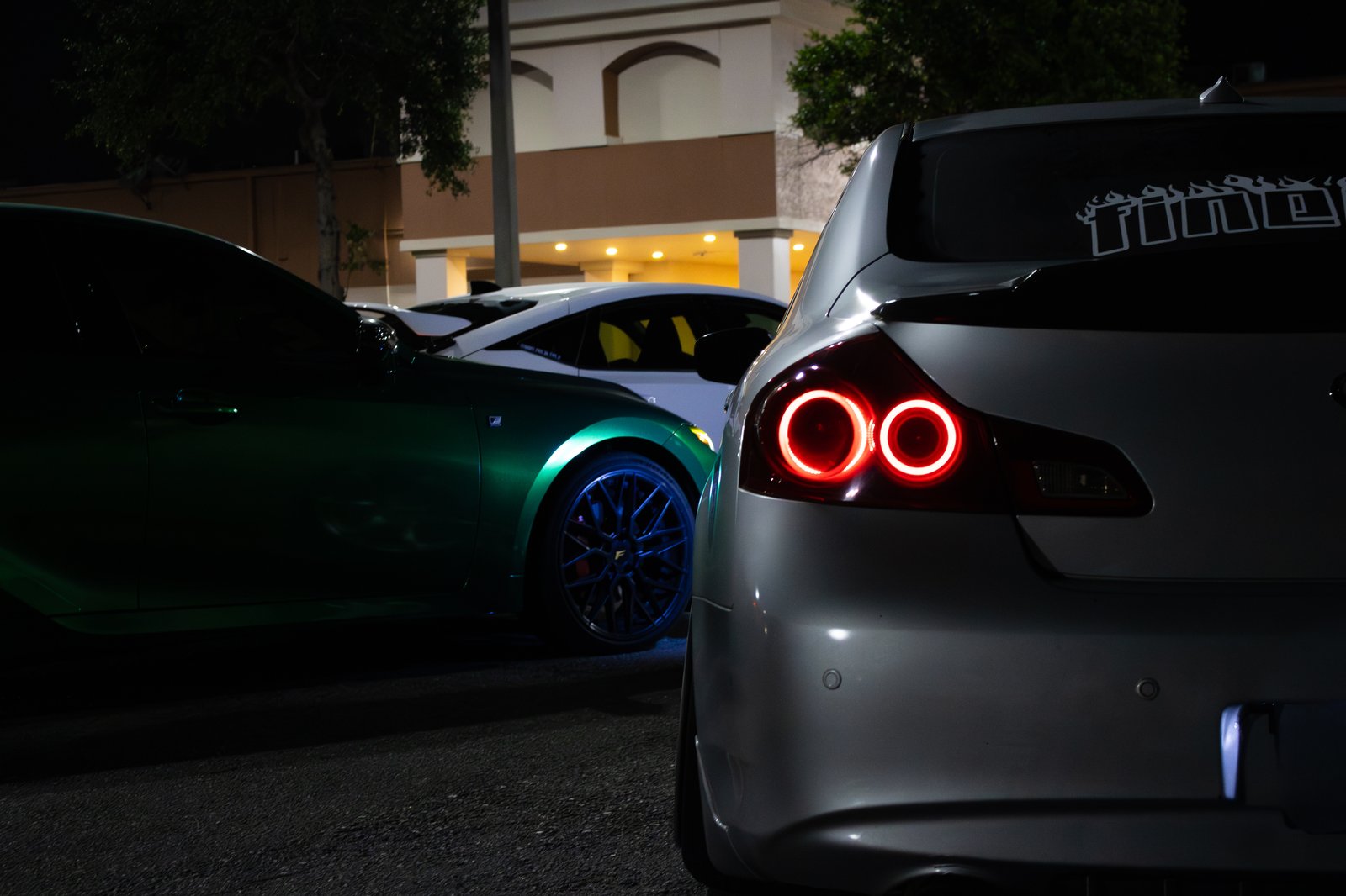 JDM hatchback with circular halo taillights at night — automotive close-up photography