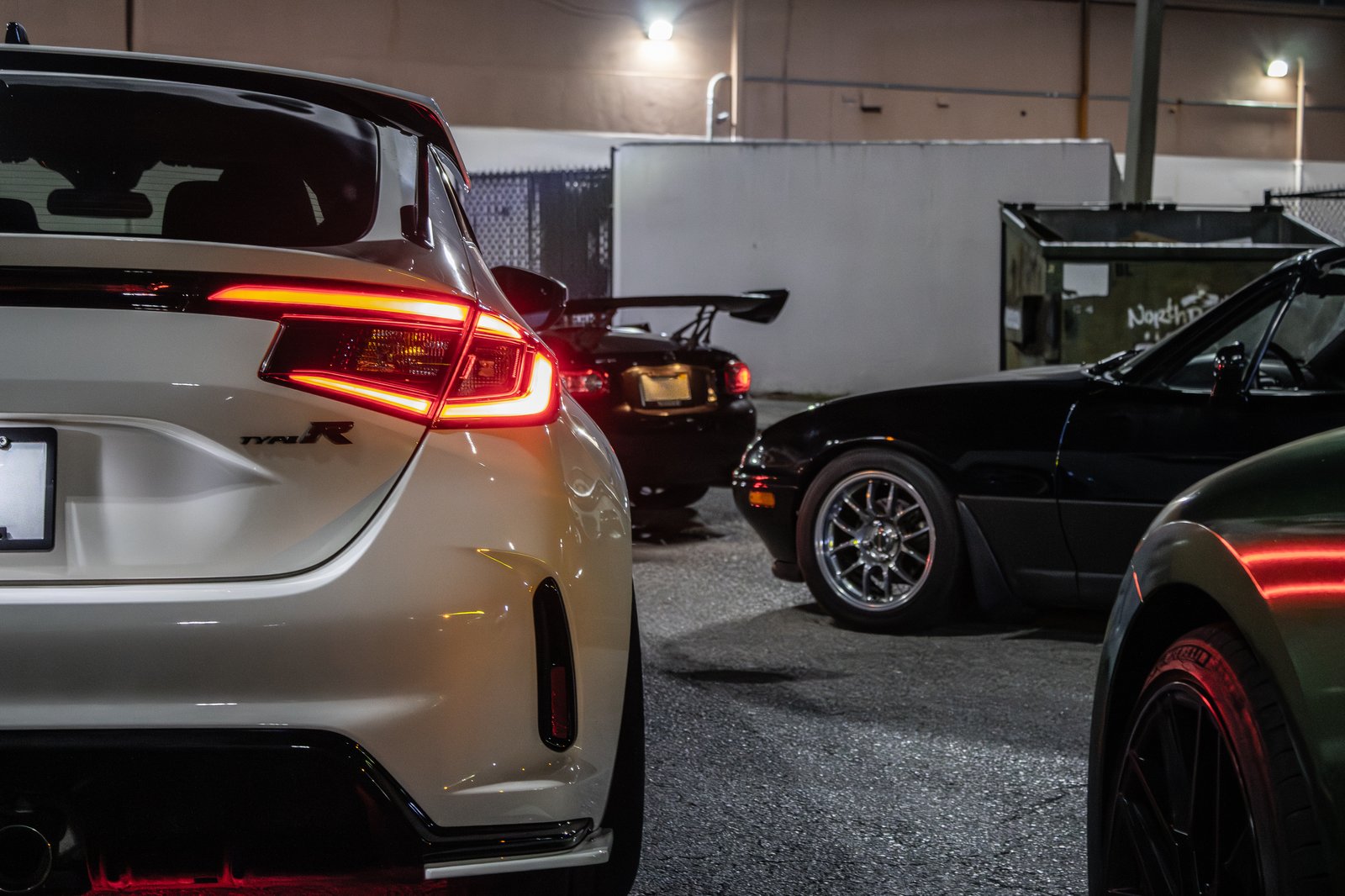 White Honda Civic Type R rear three-quarter at night next to JDM Miatas — Florida automotive scene